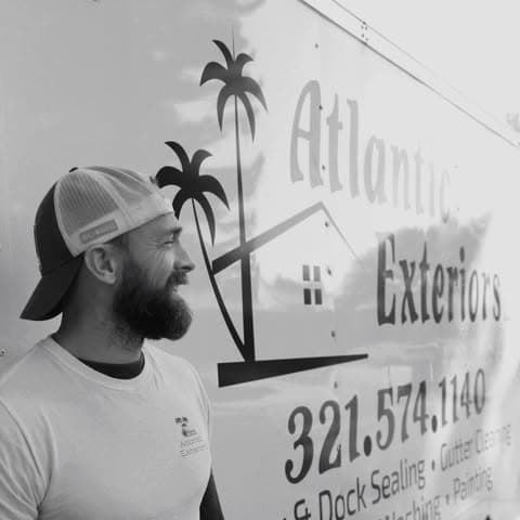 Derek Perreira, owner of Atlantic Exteriors, beside his branded service truck