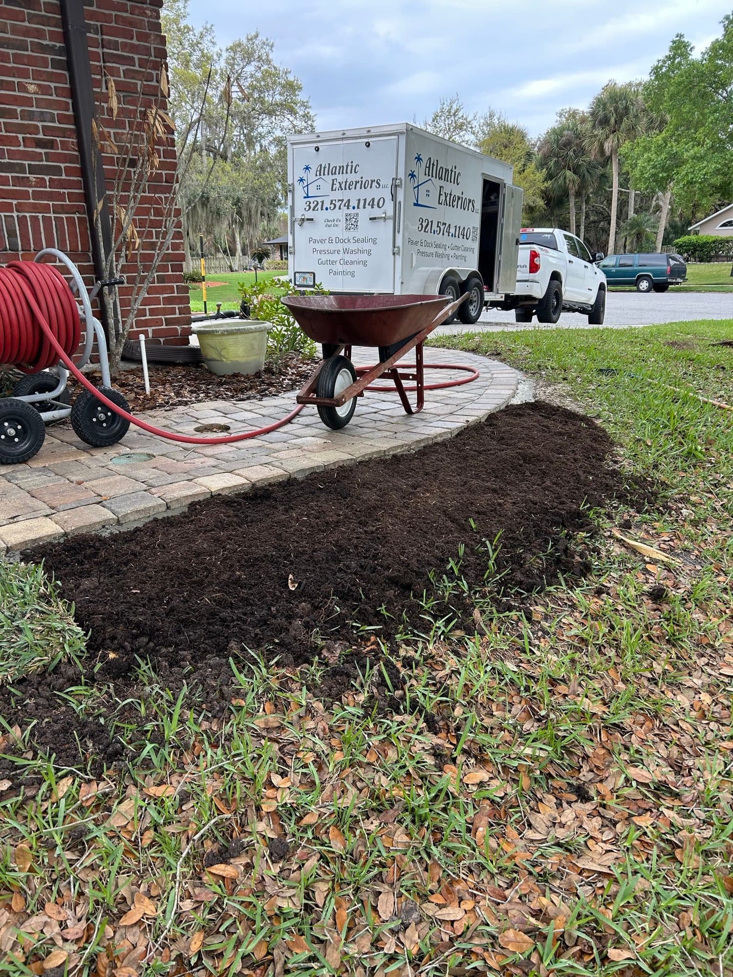 Atlantic Exteriors trailer beside fresh mulch — paver work by Atlantic Exteriors in Brevard County, FL