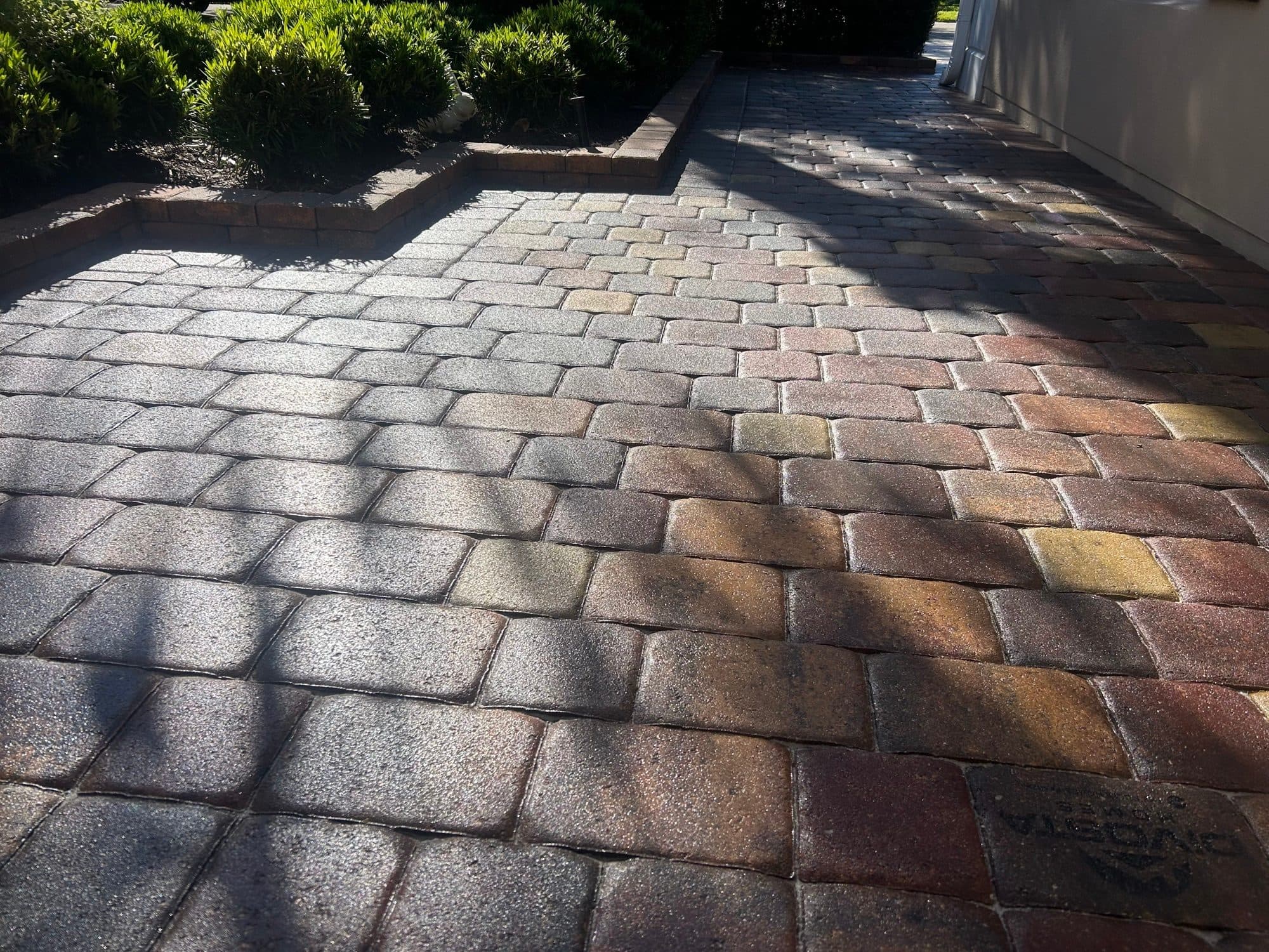 Sealed driveway with wet-look sheen — paver work by Atlantic Exteriors in Brevard County, FL