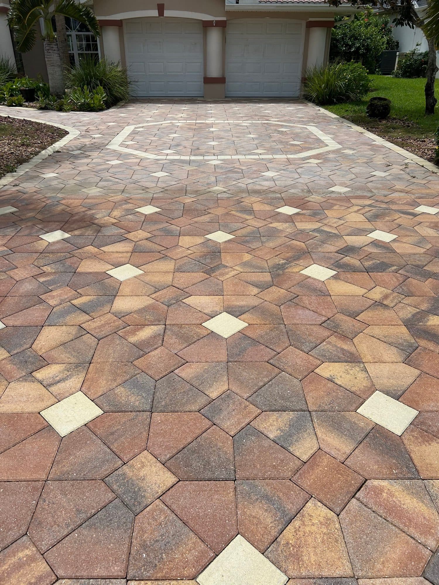 Diamond-pattern driveway with medallion — paver work by Atlantic Exteriors in Brevard County, FL