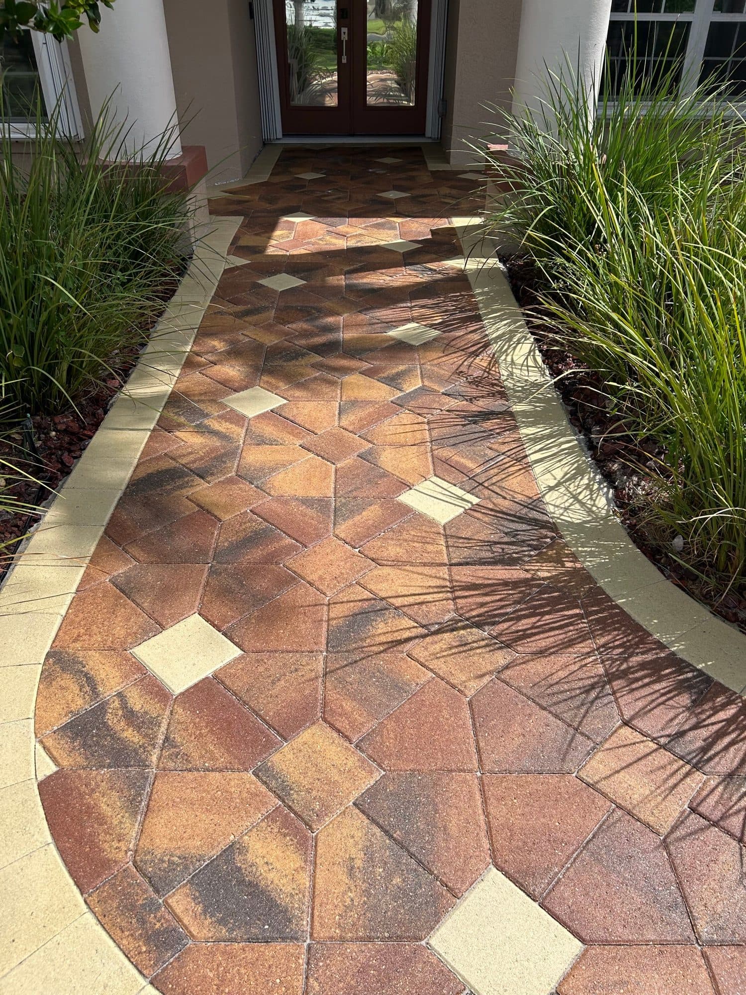 Curved entry walkway with diamond accents — paver work by Atlantic Exteriors in Brevard County, FL
