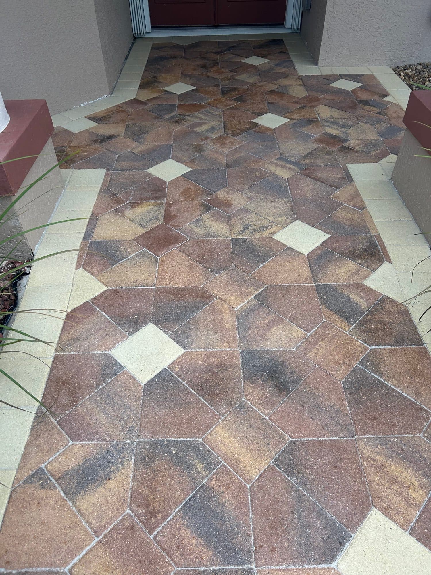 Patterned entry walkway, sealed rich — paver work by Atlantic Exteriors in Brevard County, FL