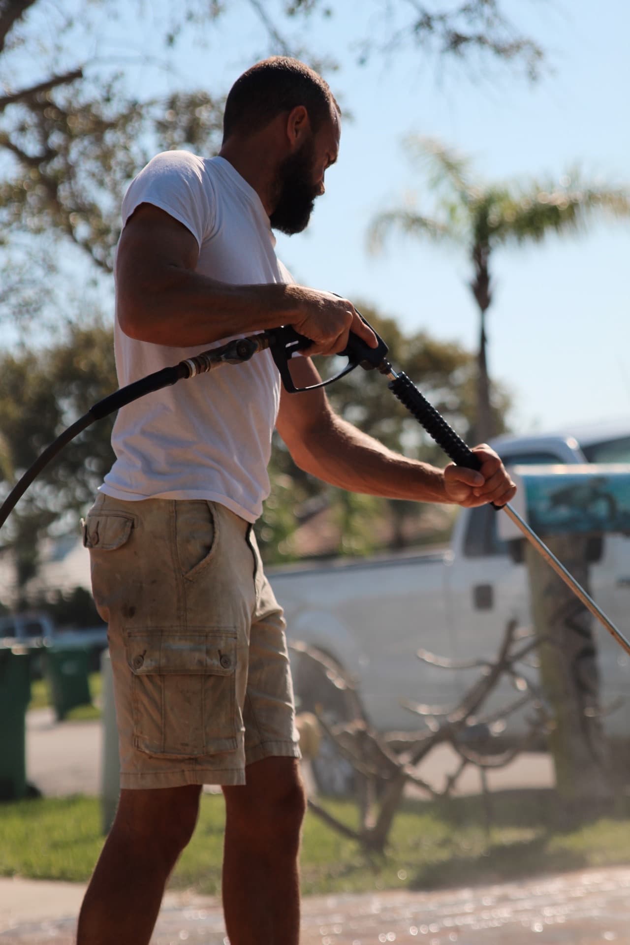 Derek pressure-washing at the curb — paver work by Atlantic Exteriors in Brevard County, FL