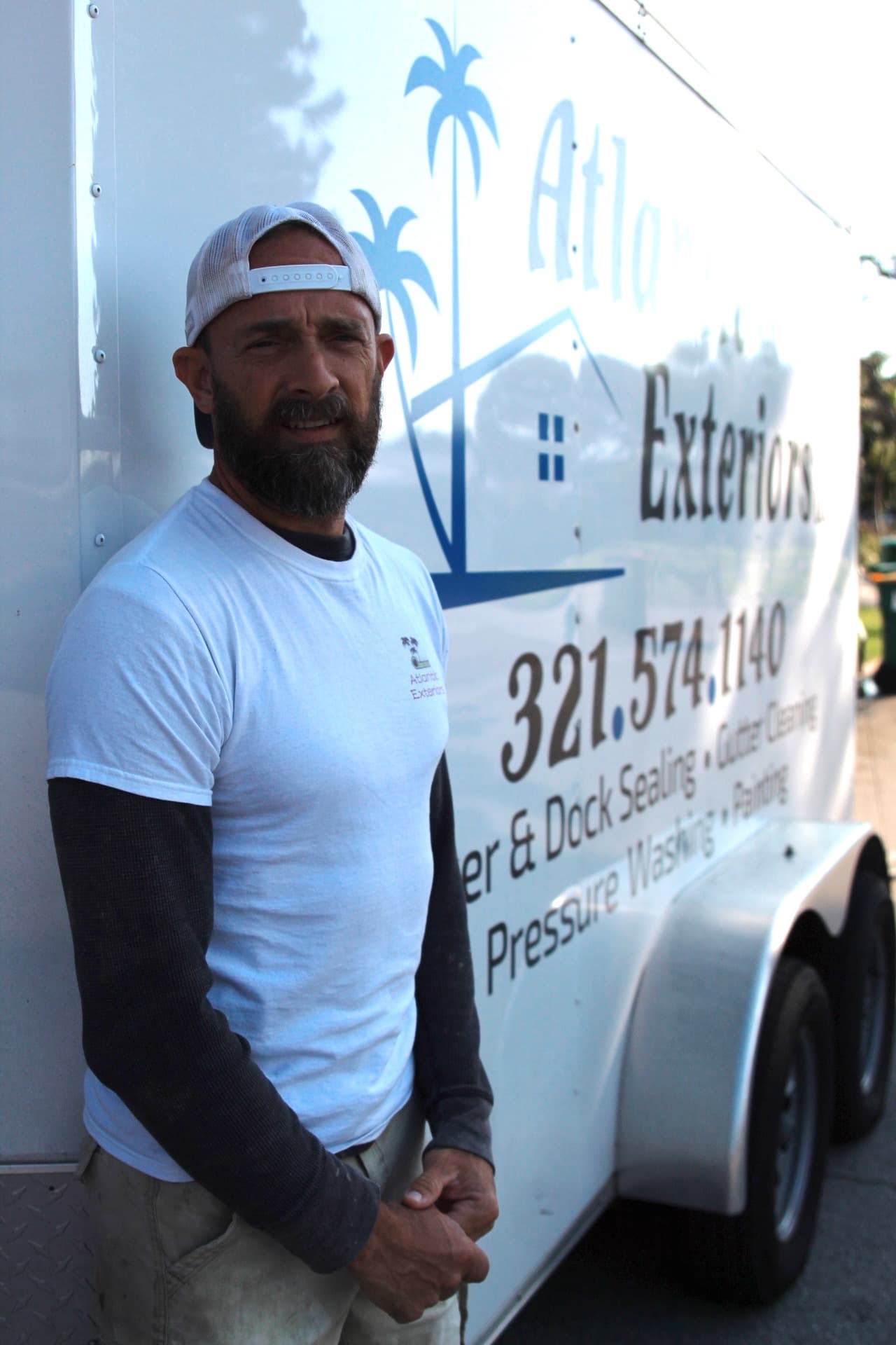 Derek beside the Atlantic Exteriors trailer — paver work by Atlantic Exteriors in Brevard County, FL
